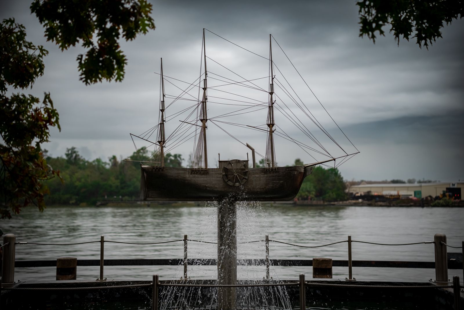 A striking ship sculpture set against the scenic Savannah River in Georgia, under a moody sky.