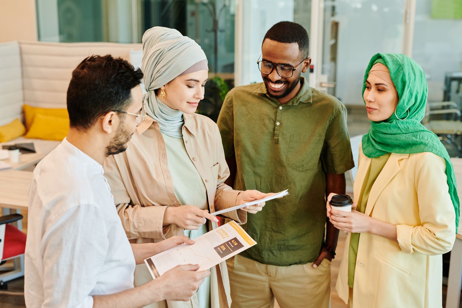 A diverse group of professionals engaged in a collaborative meeting in a modern office setting.